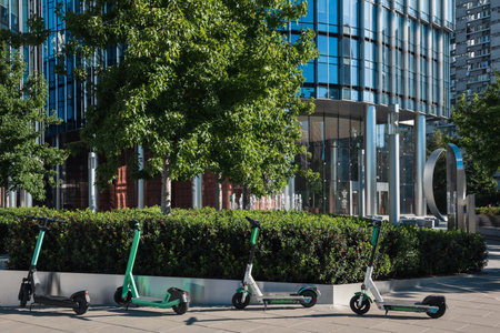 Electric scooters on the background of the entrance to the business building.の写真素材