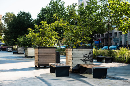 The modern city bench. The public seating area on the background of a road.の写真素材