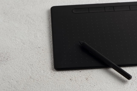 The graphic tablet with a stylus on a white background.の写真素材