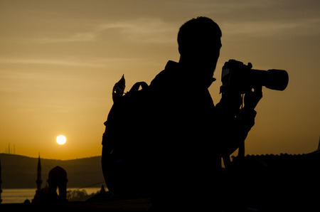 Photographers take pictures at sunrise silhouette image the first light in the morning.の写真素材