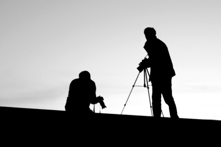 Sunrise silhouette of photographers shootingの写真素材