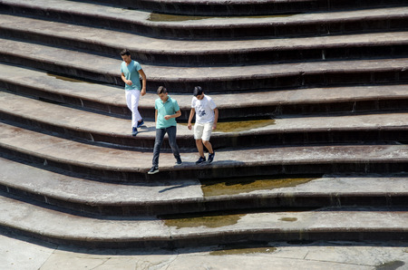 Istanbul, Turkey - July 31, 2016: Group of young people having fun on stairs, talking laughing and running.のeditorial素材