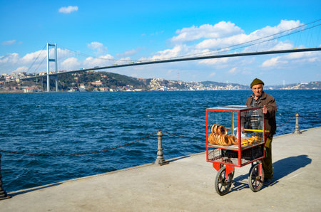 Istanbul, Turkey - March 10, 2013: Turkish vendor sells bagels, a type of Turkish bread, in the...