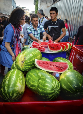 Istanbul, Turkey - May 05, 2013: Istanbul street sliced watermelon seller, a slice of watermelon buyers woman in the street.のeditorial素材