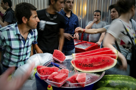 Istanbul, Turkey - May 05, 2013: Istanbul street sliced watermelon seller, Istanbul street sliced watermelon seller, a slice of watermelon buyers insanlar in the street.のeditorial素材
