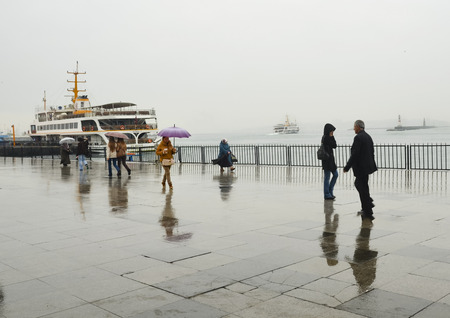 Istanbul, Turkey - April 18, 2014: Rainy Istanbul coast, people and ships. Istanbul European Side appears in the backgroundのeditorial素材