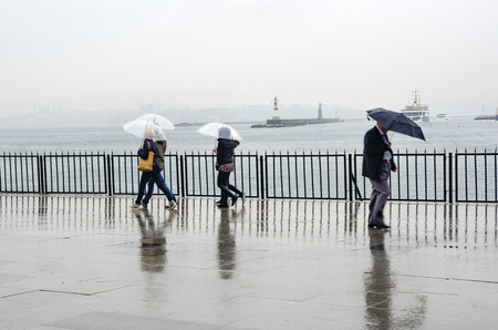 Istanbul, Turkey - April 18, 2014: Rainy Istanbul coast, people and ships. Istanbul European Side appears in the backgroundのeditorial素材