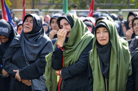 Istanbul, Turkey - October 11, 2016: Shia Muslim women mourn during an Ashura. Turkish Shia Muslims mourning for Imam Hussain. Caferis take part in a mourning procession marking the day of Ashura in Istanbul's Kucukcekmece district, Turkey on October 11, のeditorial素材