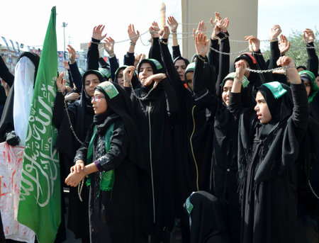 Istanbul, Turkey - October 11, 2016: Shia Muslim women shout Islamic slogans as they mourn during an Ashura procession. Turkish Shia Muslims mourning for Imam Hussain. Caferis take part in a mourning procession marking the day of Ashura in Istanbul's Kucu