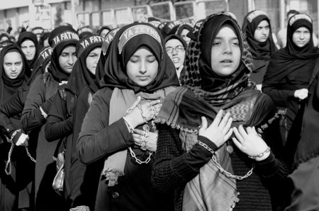 Istanbul, Turkey - October 11, 2016: Shia Muslim women shout Islamic slogans as they mourn during an...