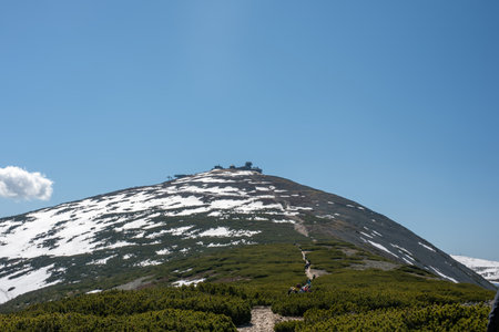 Mount SnÄÅ¾ka in the Karkonosze Mountains features an observatory at its peak, straddling the border of Poland and the Czech Republic, with stunning views.の写真素材