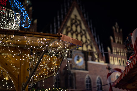 A festive Christmas market on the main square in Wroclaw, Poland, with twinkling lights, decorated stalls, and cheerful holiday atmosphere in the historic city center.の写真素材