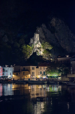 Fortress Peovica (Mirabela) overlooks Omis, Croatia, offering scenic views of the town, sea, and nearby mountains.の写真素材