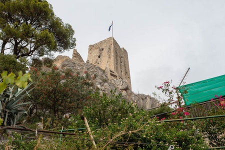 Fortress Peovica (Mirabela) overlooks Omis, Croatia, offering scenic views of the town, sea, and...
