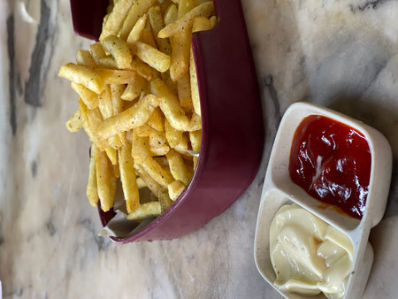 Close-up of food in bowl on table. Seaweed fries with mayonnaise and chili sauce.