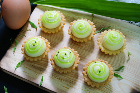High angle view of cheese tart on wooden board.