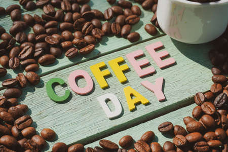 International Coffee Day text and coffee beans on the wooden background.の写真素材