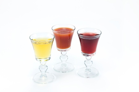 Three glass glasses of different juiceの写真素材