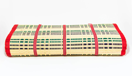 Thai style straw mat fold isolated in white の写真素材