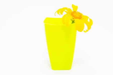 yellow  plastic mug with flowerの写真素材