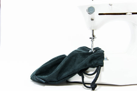 machine sewing the black bag