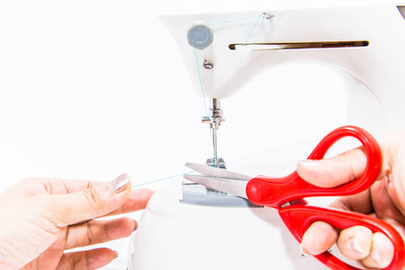A woman working with sewing machine isolate white background