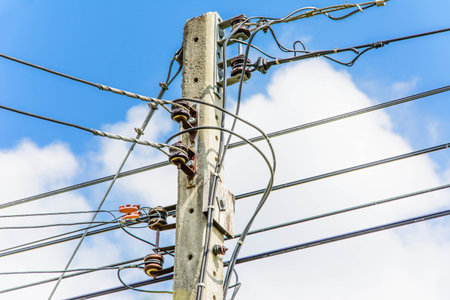 electric pole and lines againts bule sky background (close up)