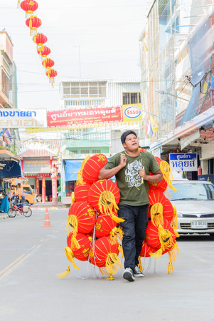 A man going to hangred Chinese style  lanterns  decorated for traditional Thai festivalのeditorial素材