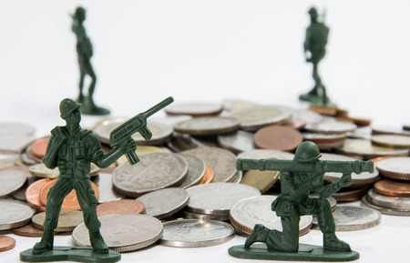soldier toy stand surround coins guarding money (shallow depth of field)の写真素材
