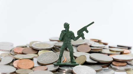 soldier toy stand on coins guarding money ( shallow depth of field)の写真素材