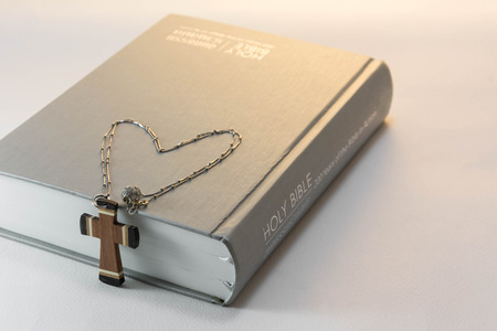 bible and wooden cross on white backgroundの写真素材