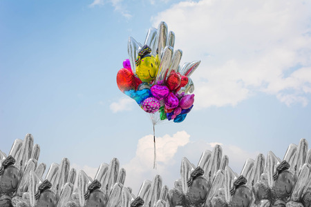 colorful of Helium Balloon among a group of balloons against blue skyの写真素材