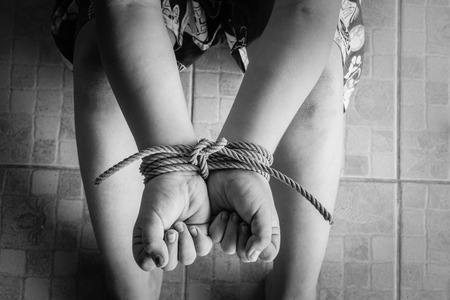 photo of children hand tied, imprison, retarded, Child Abuse in white toneの写真素材