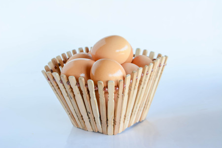 eggs in basket on white backgroundの写真素材
