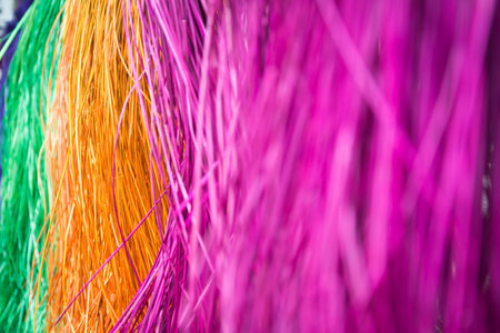 soft focus (depth on field)?many color of dry straw mats hanging on bamboo barの写真素材
