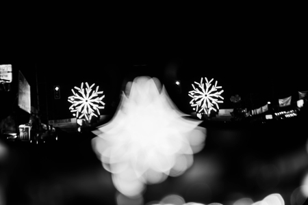 Abstract motion blur of lights on street in festival in white toneの写真素材