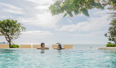 young people playing water in swimming poolの写真素材