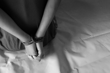 photo of children hand tied, imprison, retarded, Child Abuse in white toneの写真素材