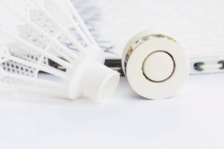 Shuttlecock and racket on white background