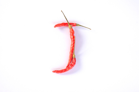 Red hot thai spicy chili alphabet "J" on whiteの写真素材