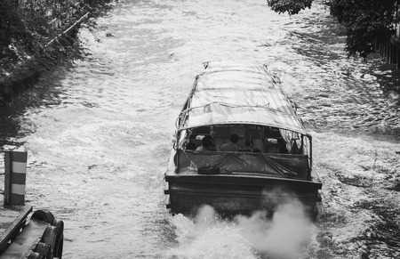 motion blur of passenger boat driving in canal and delivering passenger (soft focus) on Tachang port , 20 September 2016, 9:40 AM at Tachang Bridge, Rachathawee, Thailand passenger boat driving in canal in Thailandのeditorial素材