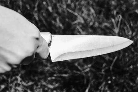 murdered holding knife in white tone with shadow edgeの写真素材