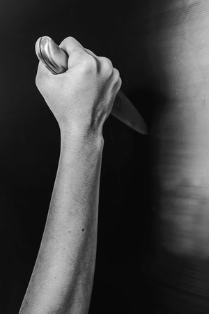 murdered holding knife in white tone with shadow edgeの写真素材