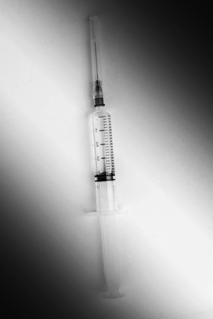 hypodermic syringes on white background in white toneの写真素材