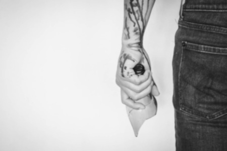 blurry Man threatening with broken beer bottle as weapon, bleeding stain in white tone with shadow edgeの写真素材