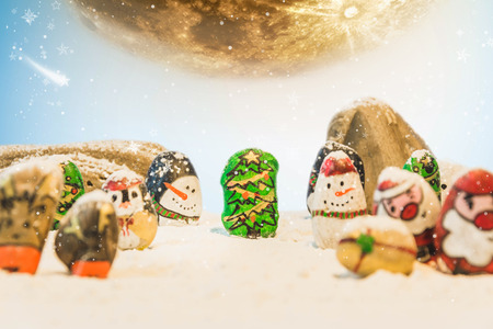 Merry Christmas and Happy New Year beautiful background. Decorated with  Christmas cartoon painting rock : Santa claus, deers, snow man, Christmas trees, gifts, star and moonの写真素材