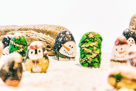 Merry Christmas and Happy New Year beautiful on white background. Decorated with  Christmas cartoon painting rock : Santa claus, deers, snow man, Christmas trees, gifts, star.の写真素材