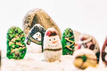 Merry Christmas and Happy New Year beautiful on white background. Decorated with  Christmas cartoon painting rock : Santa claus, deers, snow man, Christmas trees, gifts, star.の写真素材