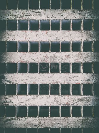 Sewer cover, drain hole at sidewalk of portの写真素材