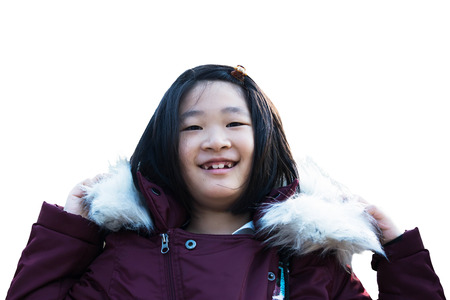 beautiful girl wearing a fur hooded winter coat in the mountains outdoor portrait isolated on white.の写真素材